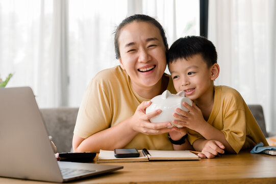 Family Saving Money Concept, Asian Woman And Son Note Family Expenditures For A Plan To Spend The Future In Earnest, Family And Financial Concept, Finance And Saving, Save Money. Family Budget Plan.