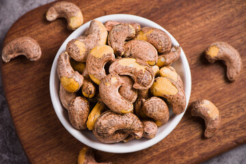 cashew nuts in plate on wooden background