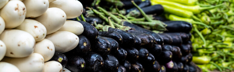 Purple and White eggplant, green bell pepper in the Egyptian food market.