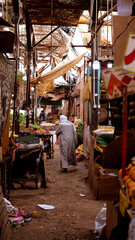 Arab man on Egyptian traditional farmer market sells fresh fruits and vegetables. el Dahar bazaar, Hurghada, Egypt