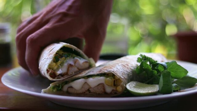 Men's hands take a burrito. delicious healthy food. shawarma, doner, kebab. Healthy lunch. slow motion