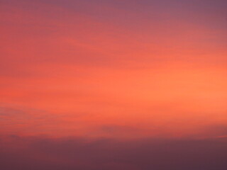 Background image of sky with beautiful pastel pink and orange clouds in the evening as the sun sets. calm sky in winter evening
