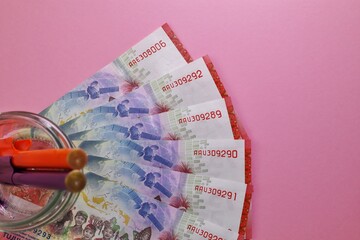 Rupiah the official currency of Indonesia. Business and finance concept. Uang 75000 Rupiah. Bank...