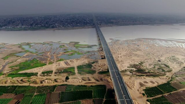 The highway and bridge over the Benue River in Makurdi Town, Nigeria - high altitude aerial view of the highway and farmlands