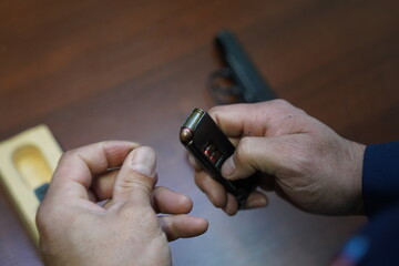 Fototapeta premium Almaty, Kazakhstan - 11.05.2021 : A police officer checks the cartridges in the pistol magazine