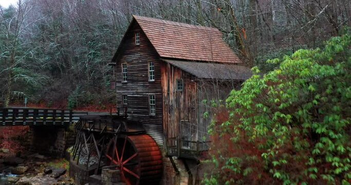 Glade Creek Grist Mill in West Virginia with bridge and drone video moving out.