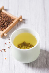 buckwheat tea in cup on  wood background.
