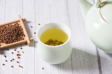 buckwheat tea in cup on  wood background.