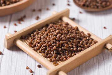 dry buckwheat on  wood background.