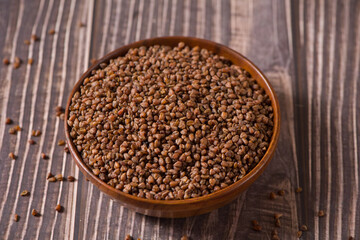 dry buckwheat on  wood background.