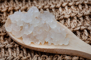 Water Kefir grains on wooden spoon with rustic background