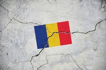 An old image of the flag of Romania on a wall with a crack.