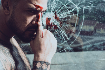 Brutal man, serious bloody face of male model, concept of men power and strong. Gang guy. Spooky...