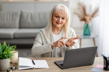 Portrait of senior woman spraying sanitizer on hand