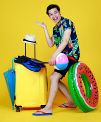 Young Asian man posing funny acting as happy tourist preparing for sea trip of summer vacation with outdoor sports equipment