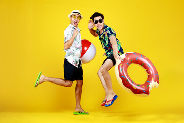 Young naughty guys in hot summer dresses acting funny jump with float ball and swimming tube as enjoy beach vacation with outdoor recreation game to play with happy friend