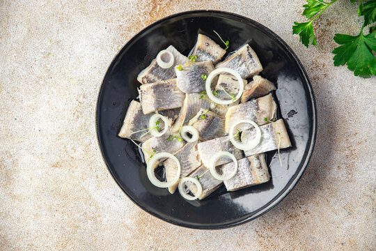 herring slice pieces of fish with onion seafood healthy meal food snack on the table copy space food background rustic top view keto or paleo diet pescetarian 
