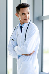 Smart Asian cardiologist and physician friendly smiling and happy to welcome service for medical healing by stethoscope