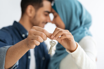Key chain in loving muslim couple hands, selective focus