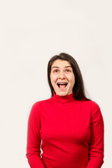 A brunette woman in a red sweater laughs with her mouth open and looks up, a place to text