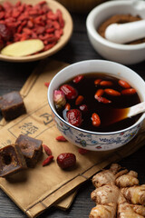 Brown sugar ginger jujube tea and Chinese classical medical books on the table