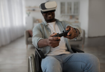Disabled male playing virtual online game, having fun with modern technologies and enjoying game