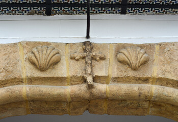 Religious catholic symbols in an arch of Utrera, Seville Province, Spain