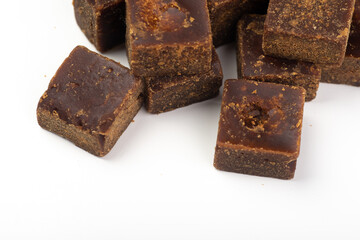 Lumpy brown sugar on a white background