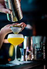 man hand bartender making sweet and sour refreshing french 75 gin cocktail on the bar counter