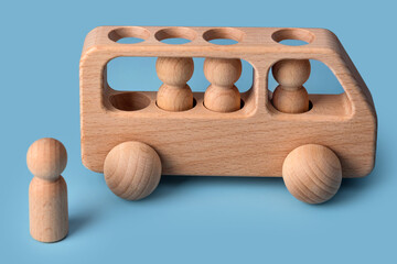 Wooden car, baby toy for child on blue background. Eco friendly, plastic free toddler kids toys. Educational Montessori learning wooden toys.