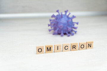 Model of corona virus with the word omicron as symbol