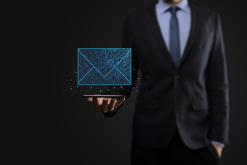 Businessman hand holding letter icon,email icons.Contact us by newsletter email and protect your...