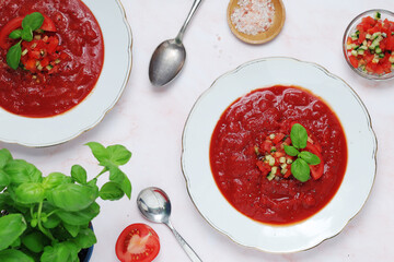 Plates with traditional gazpacho tomato soup