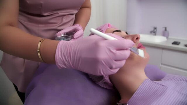 Beautiful woman receiving facial microcurrent treatment at spa salon. Beautician using electrical impulses for facial procedures. Woman in spa salon. Woman in a spa salon on cosmetic procedures.
