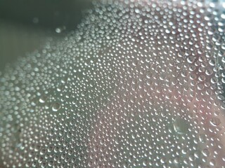 Macro of water droplets on glass with defocused background