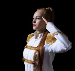 a beautiful girl poses in an officer's costume, with gold shoulder straps, on a black background