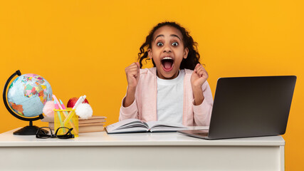 Portrait of emotional black girl screaming with raised fists