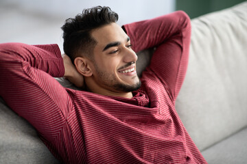 Closeup of happy arab man chilling at home