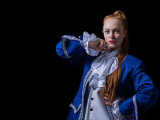 beautiful girl posing in a butler costume on a black background