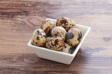 Raw quail eggs heap in the bowl