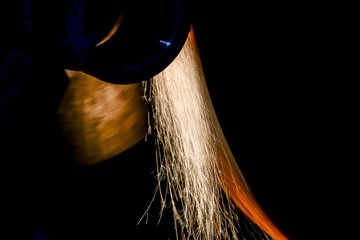 Grinding the surface of the part shaft on a cylindrical grinding machine.