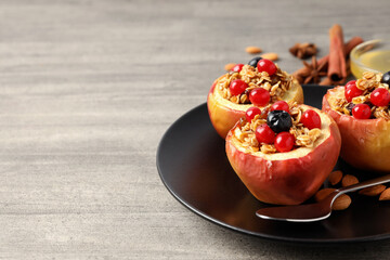 Concept of tasty food with baked apples on wooden background