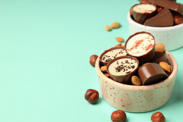 Concept of sweets with chocolate candies on mint background
