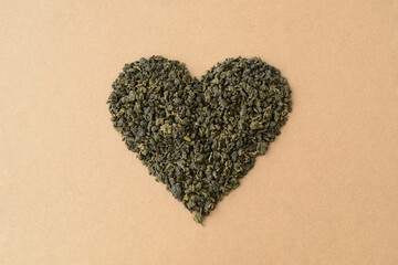 Heart shape made of green Chinese tea leaves. Milk oolong, fermented tea. Love heart, Valentines Day