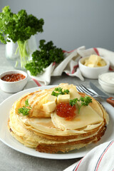 Concept of tasty food with crepes on gray textured table