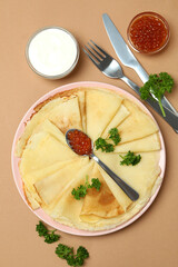 Concept of tasty food with crepes on brown background