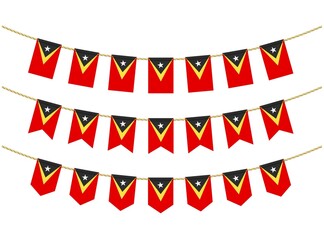 Fototapeta premium East Timor flag on the ropes on white background. Set of Patriotic bunting flags. Bunting decoration of East Timor flag