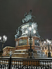 Monument to Nicholas 1 the All-Russian Emperor, surrounded by an old fence and beautiful lanterns.