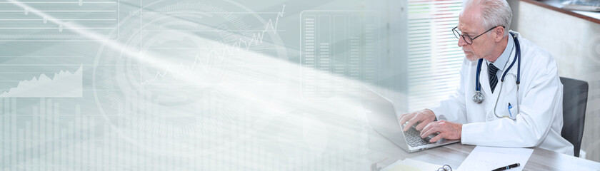 Senior doctor using laptop; panoramic banner