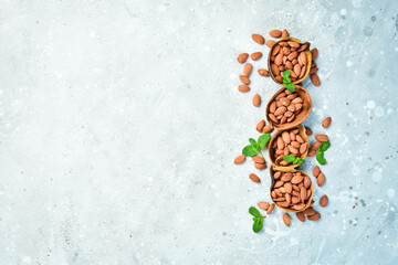 Roasted almond nut on a stone background. Top view. Food background.